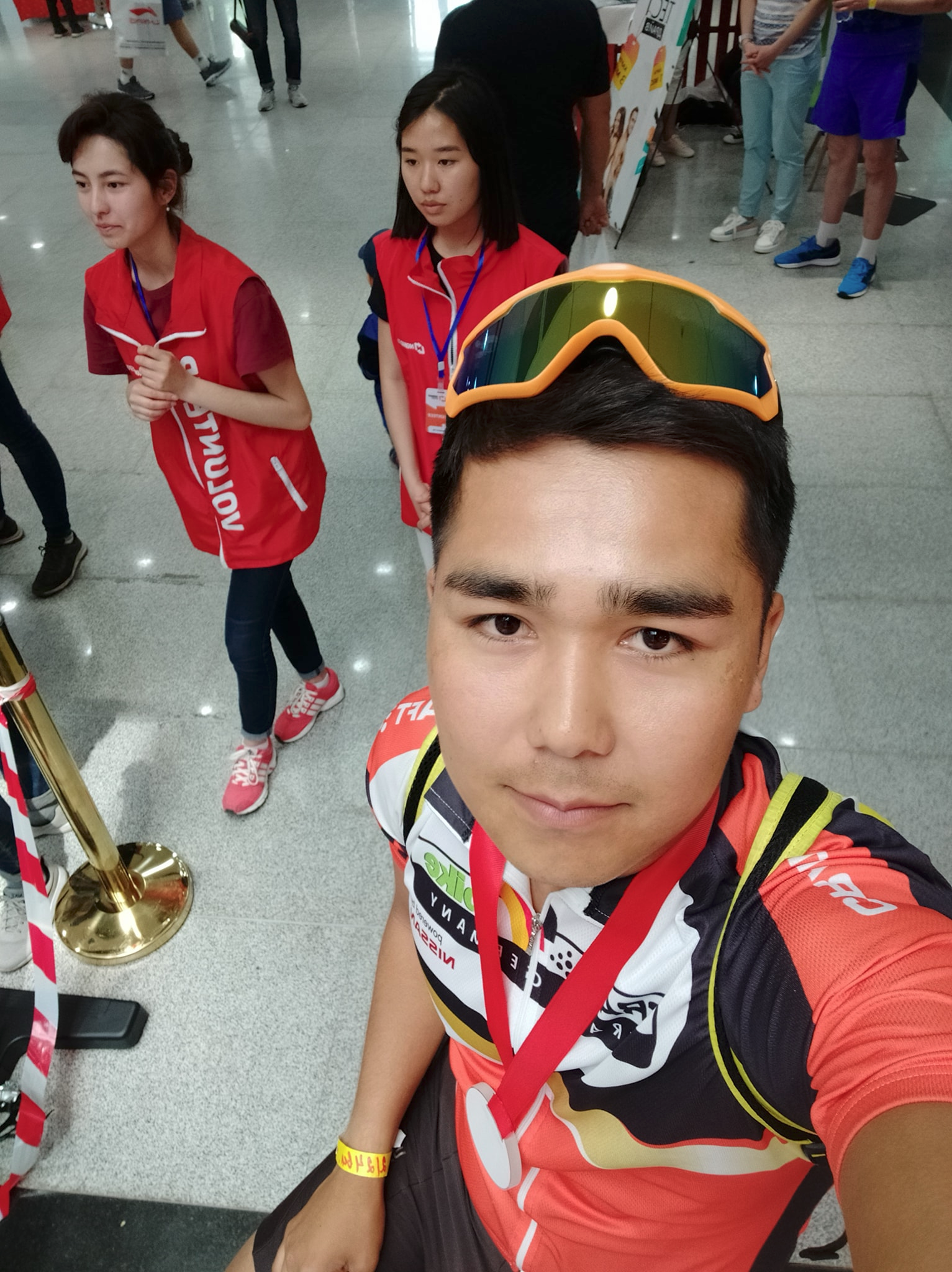 Source sports selfie with red black and yellow outfit